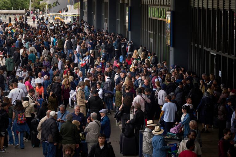 Cientos de personas esperando ante una estación de tren cerrada durante un gran apagón en Barcelona, España. (Foto: AP/Emilio Morenatti).
